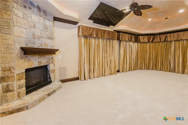 a view of a livingroom with a fireplace and a chandelier