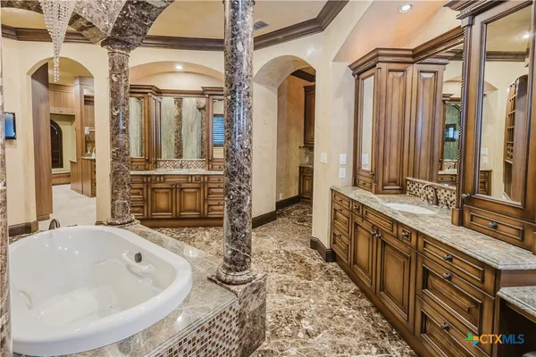 a bathroom with a double vanity sink and a bathtub