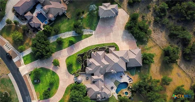 an aerial view of a house with outdoor space and a lake view