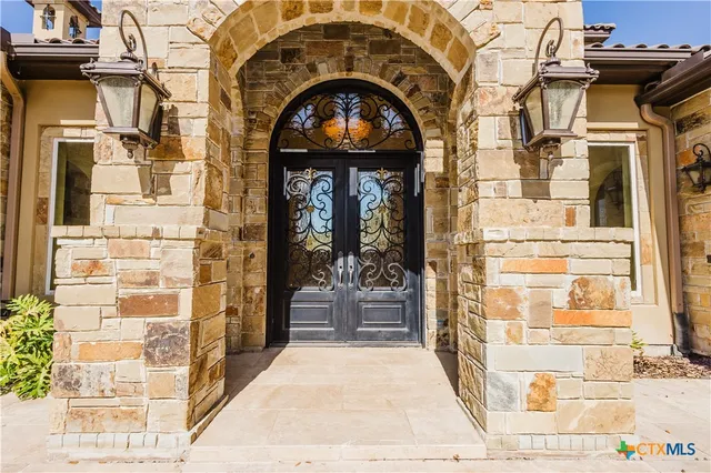 a living room with furniture a fireplace and a dining table with garden view