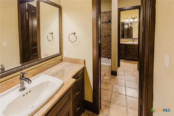 a bathroom with a sink and a mirror