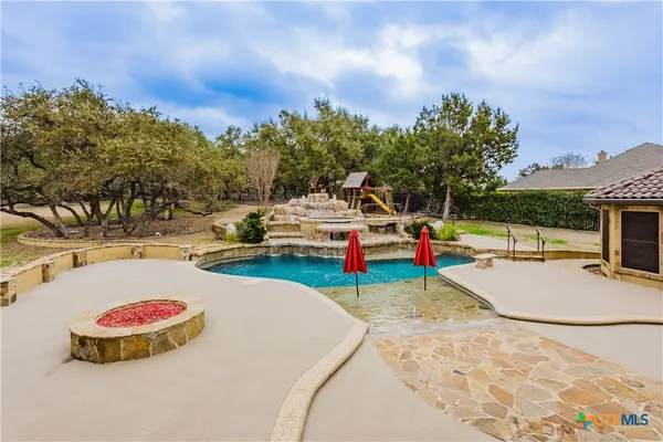 a view of a swimming pool with lounge chair