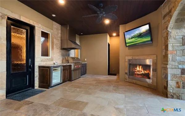a kitchen with stainless steel appliances granite countertop a refrigerator a stove top oven a sink and dishwasher