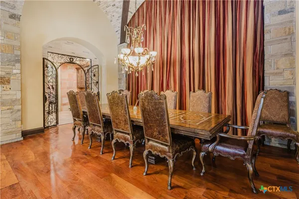 a view of a dining room with furniture and chandelier