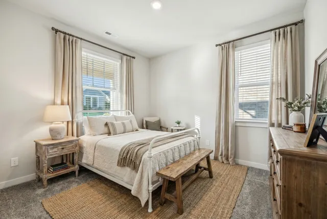 a bedroom with a bed and a potted plant