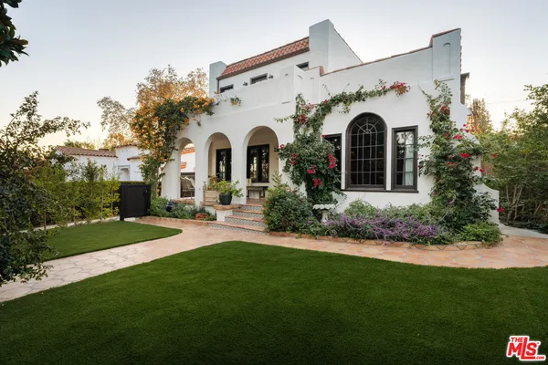 a view of a house with garden and yard