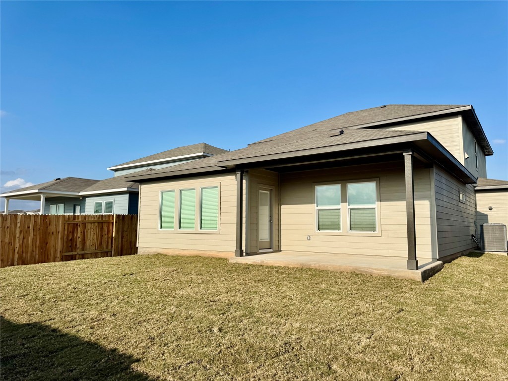 298 Texas Agate Drive Kyle, TX 78640 - Photo 5 of 7 Rear view of property featuring a patio area and roof with shingles