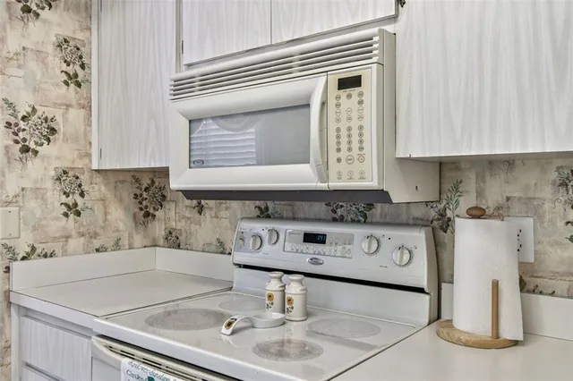 a view of living room with furniture and a potted plant