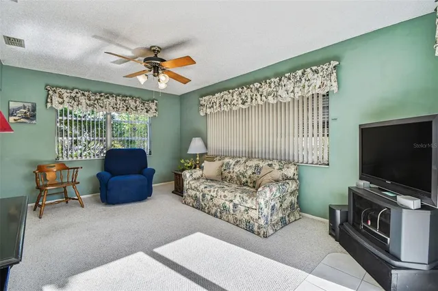 a view of an empty room with cabinet and a flat screen tv