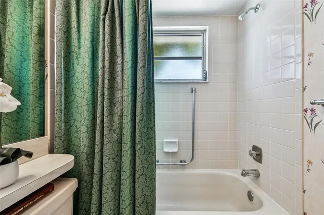 an aerial view of a house with a garden and lake view