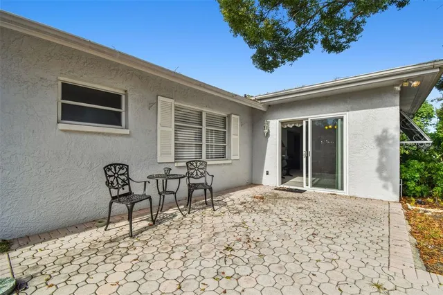 an aerial view of a house with a yard and potted plants
