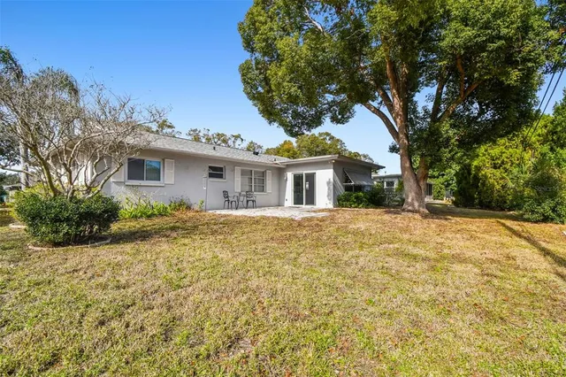 an aerial view of a city with lots of residential buildings ocean and mountain view in back
