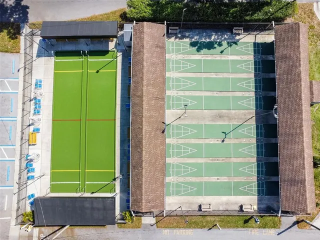 an aerial view of a house with a yard and lake view