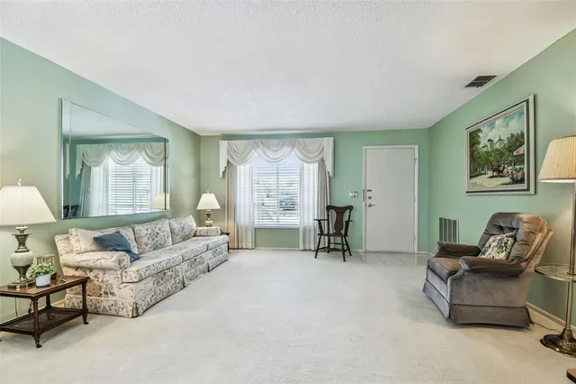 a view of a dining room with furniture and windows