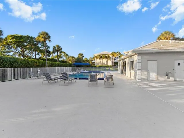 an outdoor view of house with swimming pool and outdoor seating