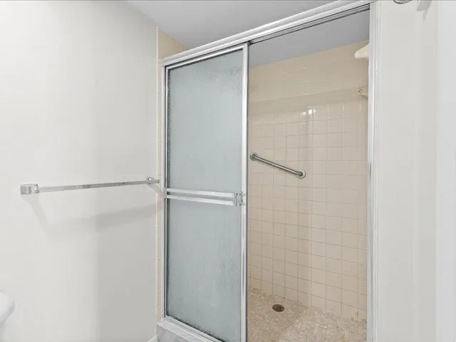 a bathroom with a glass shower door
