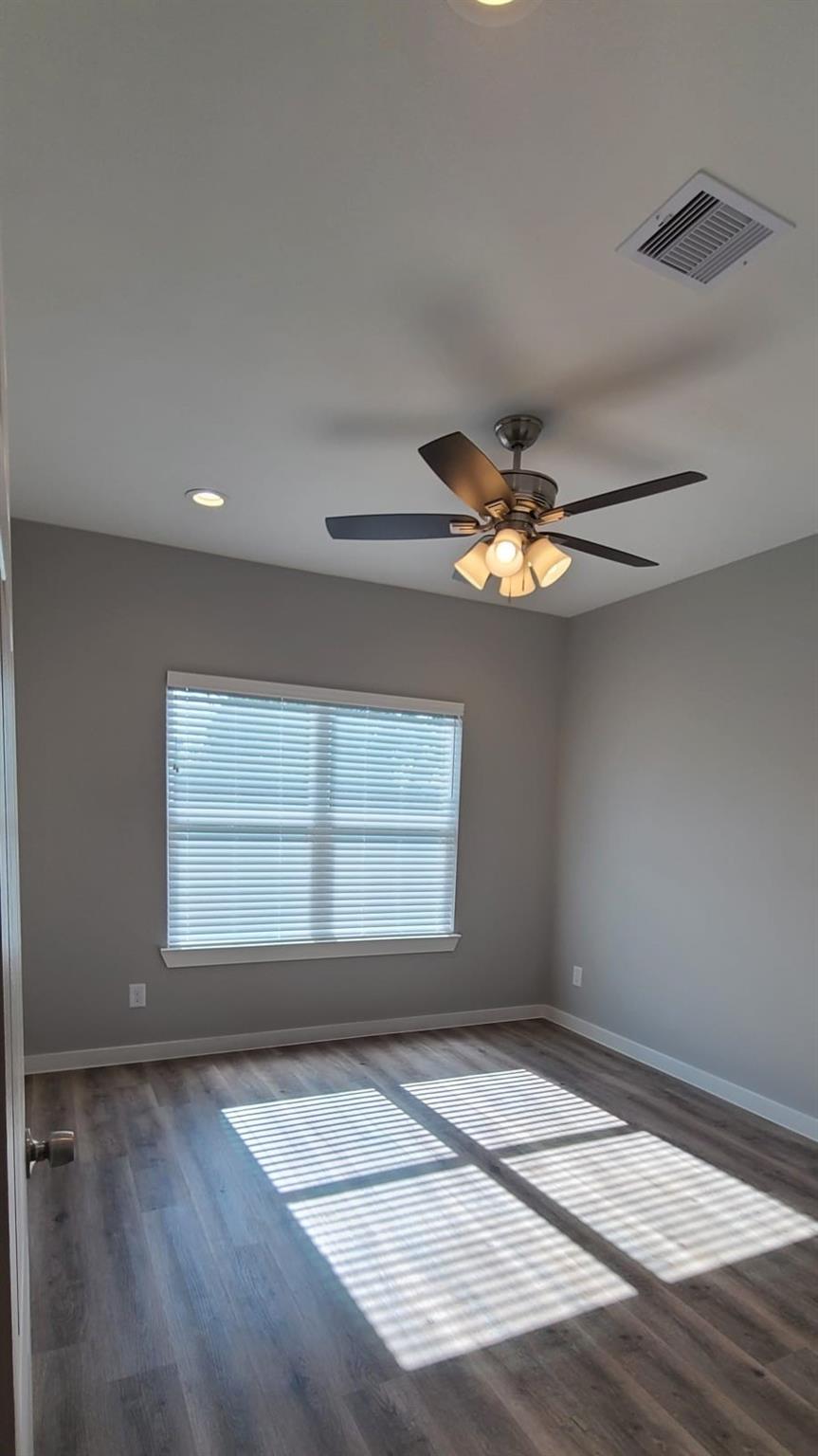 9114 Caddo Road, Unit A & B Houston, TX 77078 - Photo 13 of 24 A quiet bedroom offering resilient wood-look flooring and efficient ceiling fan.