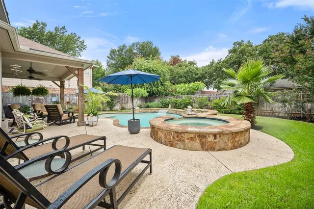 a view of a swimming pool with a table and chairs