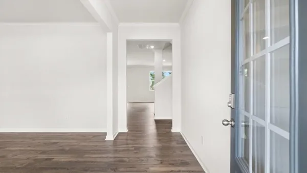 a view of a hallway with wooden floor