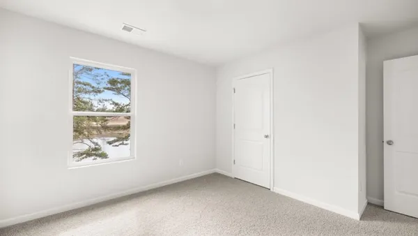 a view of room with window and hallway
