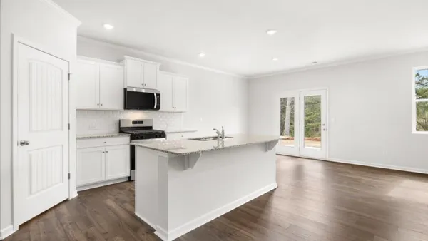 a kitchen with appliances a sink and cabinets