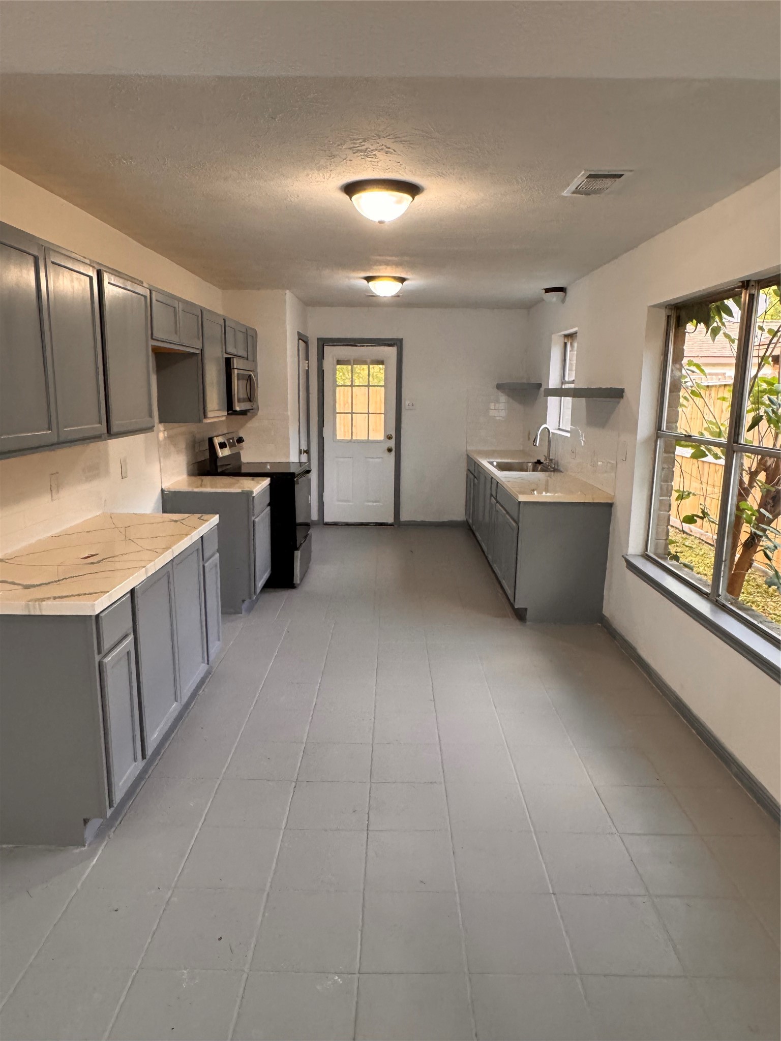 604 Briarclift Lane Baytown, TX 77521 - Photo 5 of 12 a large white kitchen with a large window