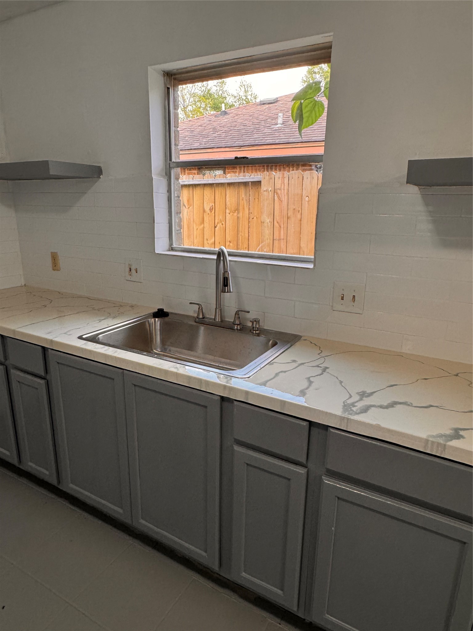 604 Briarclift Lane Baytown, TX 77521 - Photo 6 of 12 a bathroom with a granite countertop sink and a window