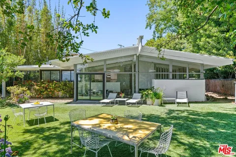 a backyard of a house with yard and outdoor seating