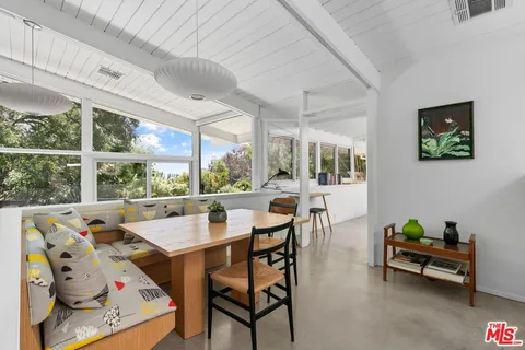 a view of a dining room with furniture window and outside view