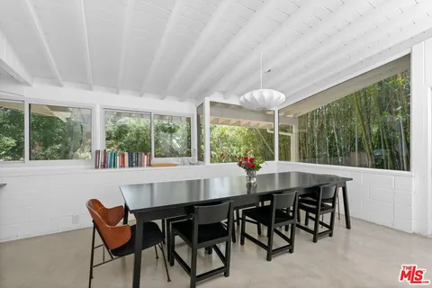 a dining room with furniture window and outside view