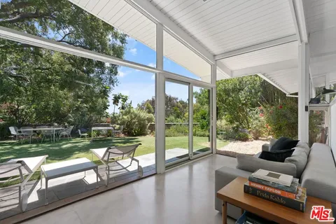 a view of swimming pool with a couches in a patio