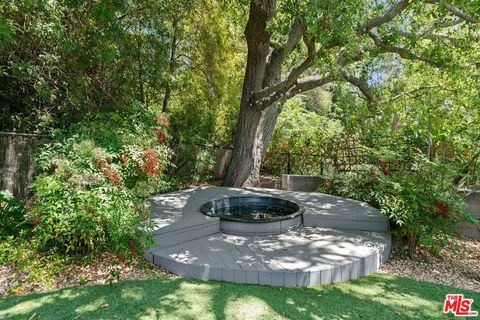 a view of a backyard with table and chairs