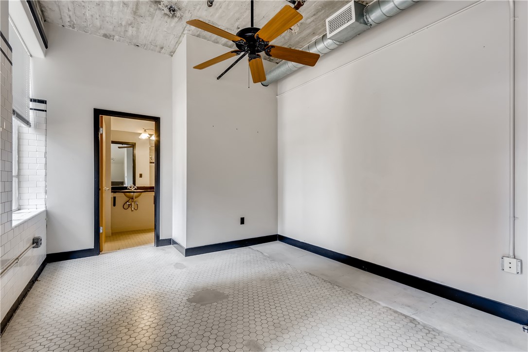 710 Colorado Street, Unit 4J Austin, TX 78701 - Photo 17 of 37 High ceilings, exposed ductwork. Ensuite full bath