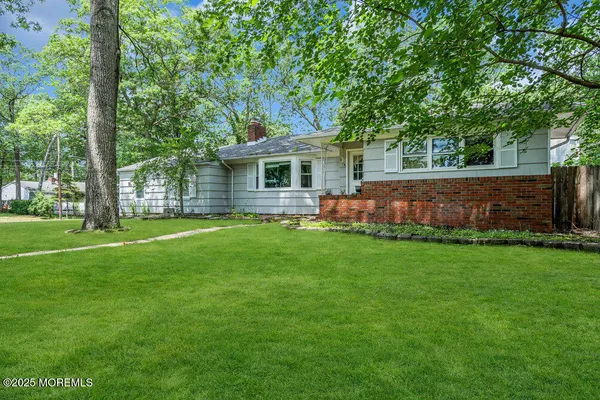 a front view of house with yard and green space