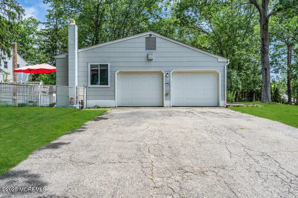 a front view of house with yard and green space