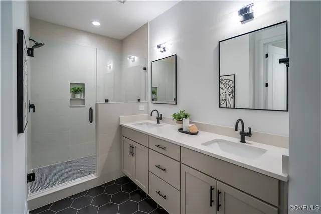 a bathroom with double sink and a mirror