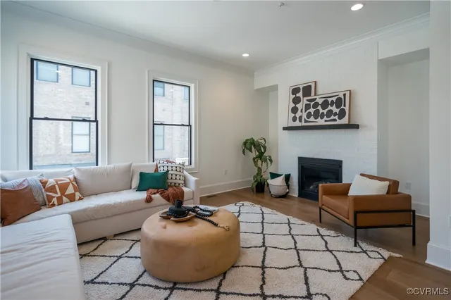 a living room with furniture a fireplace and a table