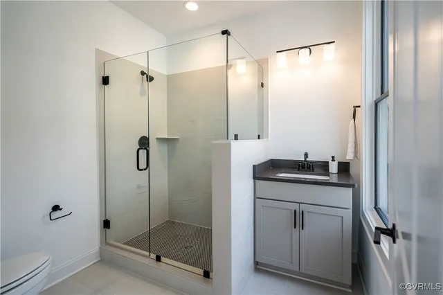 a bathroom with a shower sink and mirror