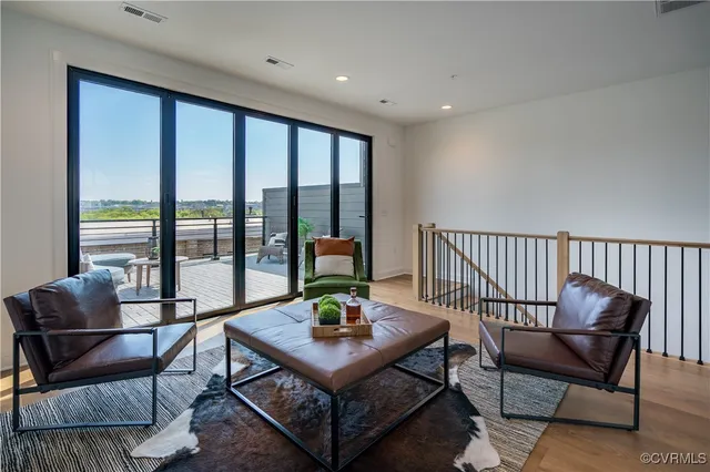 a living room with furniture and a potted plant