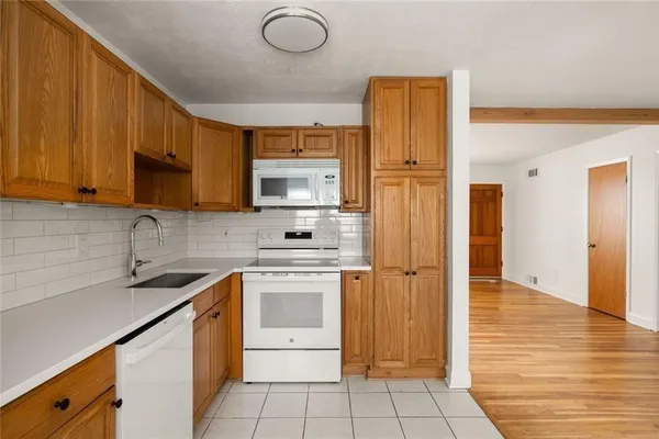 a kitchen with stainless steel appliances granite countertop a sink a stove microwave and cabinets