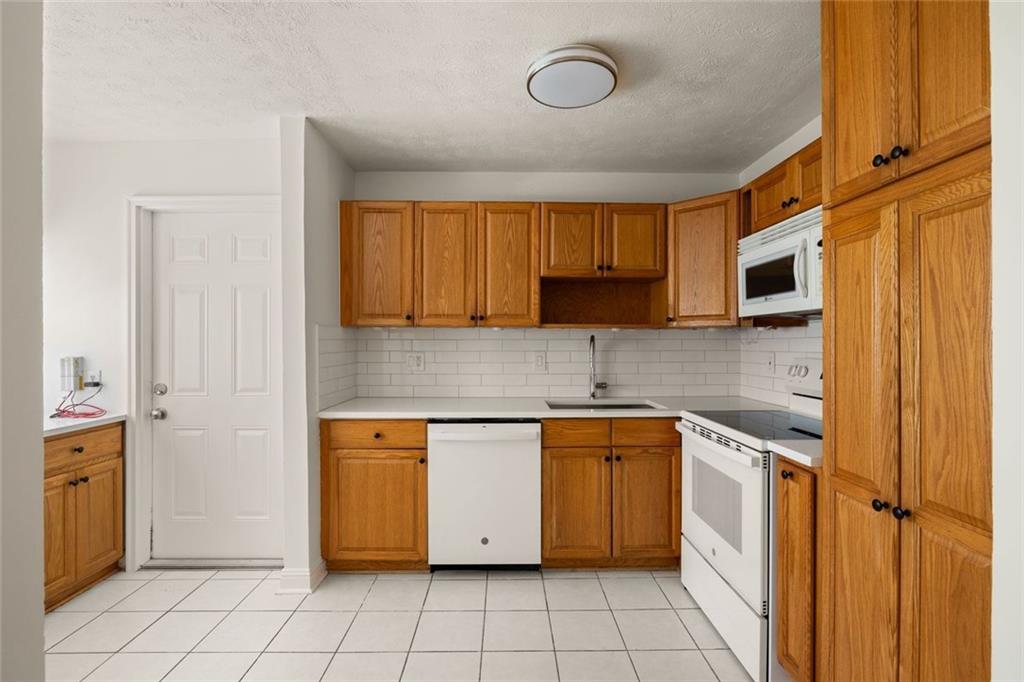 2941 Caldwell Road Northeast, Unit B4 Brookhaven, GA 30319 - Photo 22 of 51 a kitchen with stainless steel appliances granite countertop a stove a sink and a microwave
