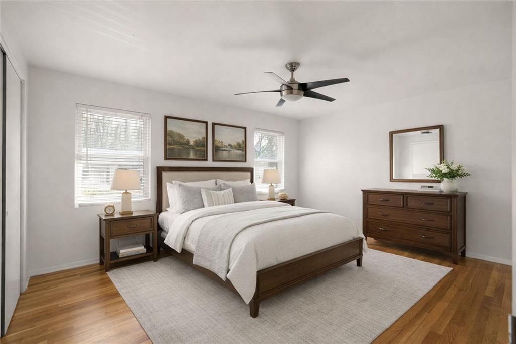 2941 Caldwell Road Northeast, Unit B4 Brookhaven, GA 30319 - Photo 4 of 51 a bedroom with a large bed a chandelier and dresser