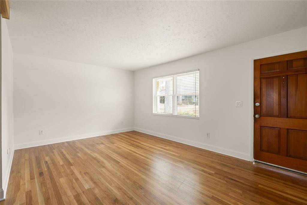 2941 Caldwell Road Northeast, Unit B4 Brookhaven, GA 30319 - Photo 7 of 51 an empty room with wooden floor and windows