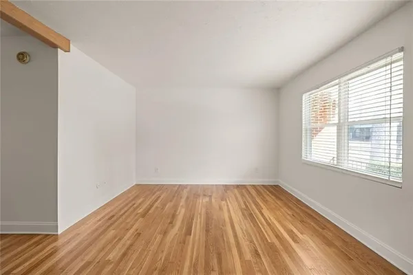 a view of a room with wooden floor and window