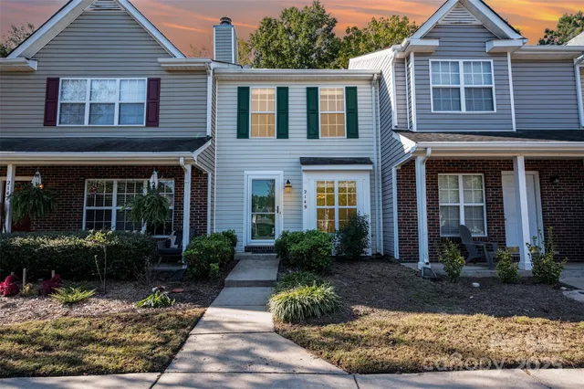 a front view of a house with garden and porch