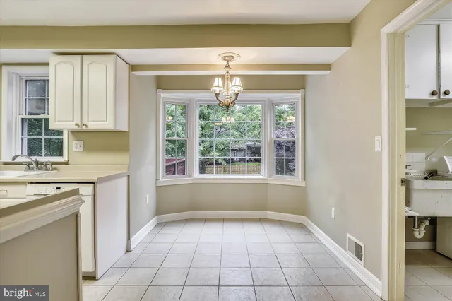 a very nice looking kitchen with granite countertop a stove in it