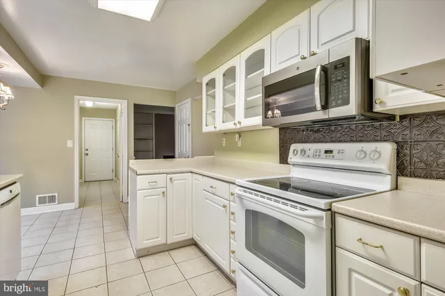 a kitchen with cabinets and appliances