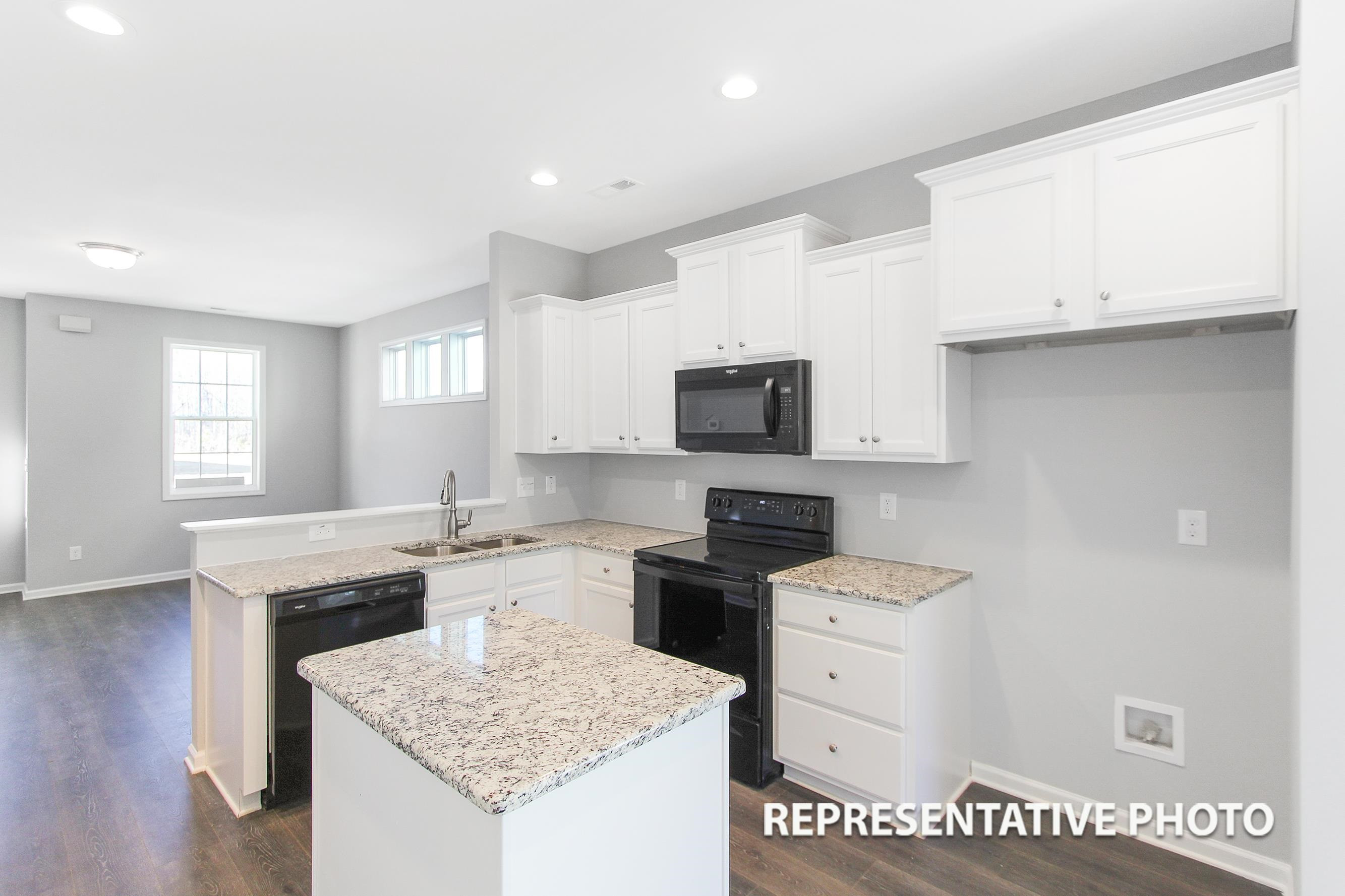148 Longbow Drive Middlesex, NC 27557 - Photo 3 of 9 a kitchen with granite countertop white cabinets and white appliances