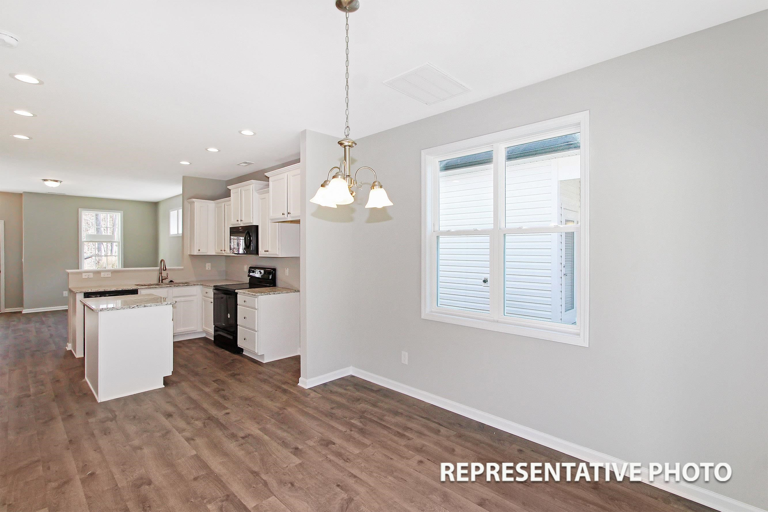 148 Longbow Drive Middlesex, NC 27557 - Photo 4 of 9 a open kitchen with white cabinets and wooden floor