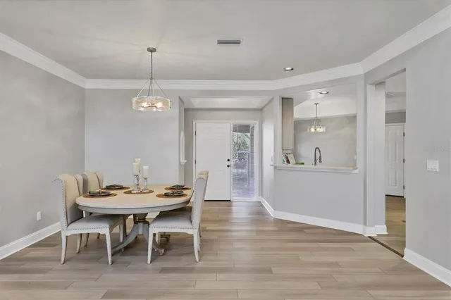 a view of a dining room with furniture wooden floor and chandelier